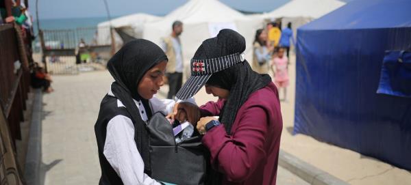 Girls affected by the o<em></em>ngoing co<em></em>nflict in Gaza receive a care and protection package distributed by UNICEF.