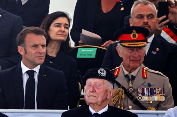 Britain's King Charles III, right, and French President Emmanuel Macron attend a ceremony in Normandy