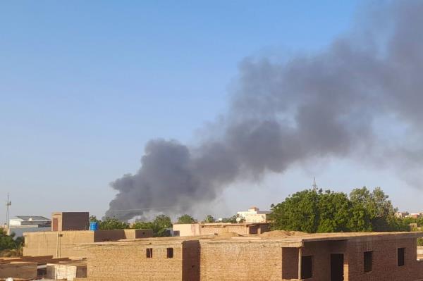Smoke billows in the distance around the Khartoum Bahri district amid o<em></em>ngoing fighting on July 14, 2023. - War-torn Sudan's capital experienced a communications blackout for several hours on July 14, residents said, as the army and paramilitary forces waged intense battles across Khartoum and humanitarian groups warned of worsening crises.