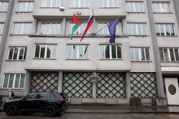A Palestinian flag flies next to a Slovenian and a European Unio<em></em>n flag, at the government building in Ljubljana, Slovenia
