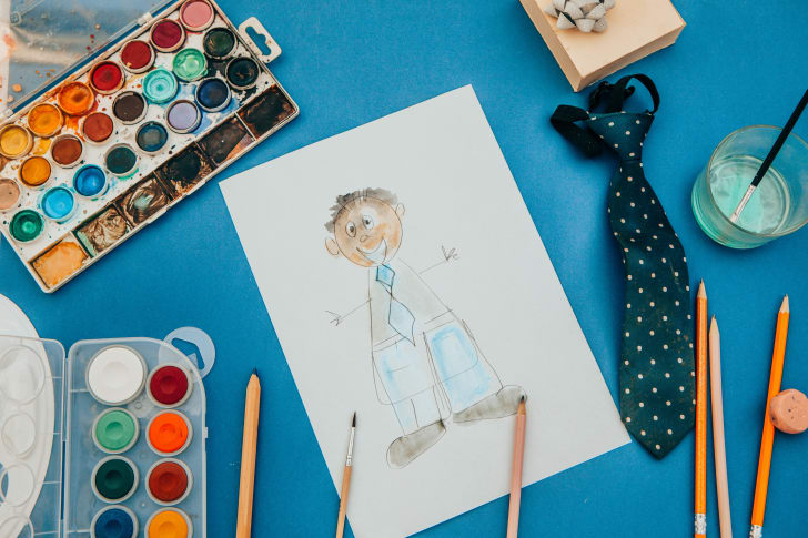 photo of a child's painting of a father near a tie for father's day