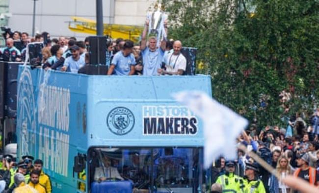 Erling Haaland lifts the Premier League trophy during City’s open-top bus parade