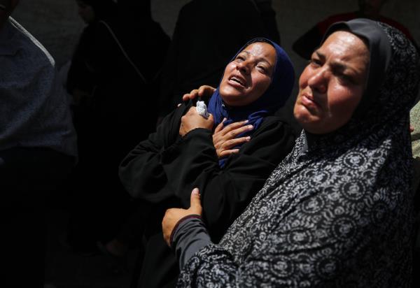 Palestinian women mourn the deaths of loved o<em></em>nes in Deir al-Balah, Gaza, on June 8. 