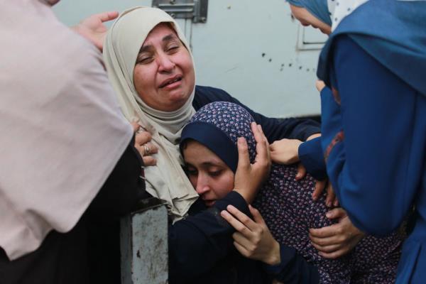 Palestinians mourn relatives killed in an Israeli bombardment in the Bureij area of central Gaza on June 4, 2024.