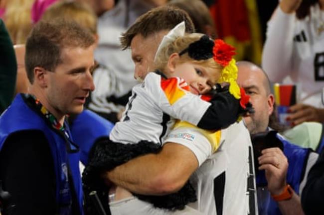 Niclas Füllkrug celebrates Germany’s victory with his daughter after the Euro 2024 group stage match between Germany and Scotland.