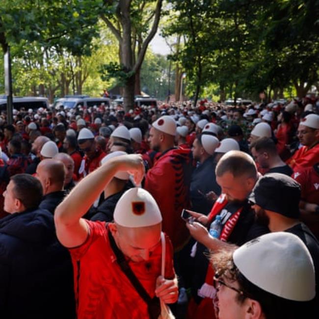 Albanian fans, many wearing a traditio<em></em>nal hat called a Qeleshe, wait to enter the stadium hours before the group game against Italy.