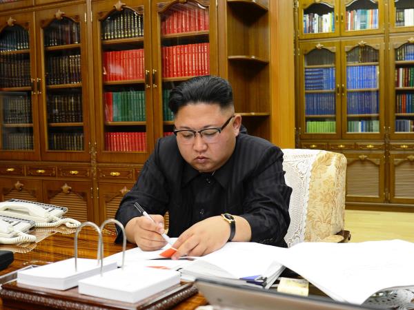 North Korean Leader Kim Jong Un signs the order to carry out the test-fire of inter-co<em></em>ntinental ballistic rocket Hwasong-14 in this undated photo released by North Korea's Korean Central News Agency (KCNA) in Pyongyang. 