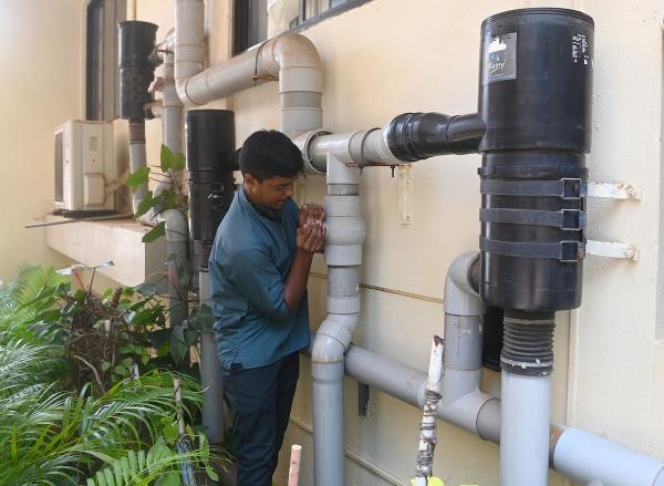 A rainwater harvesting system in a college; a student digs a percolation pit inspired by awareness programmes in school; a tank with gravel sand and charcoal used to filter rainwater.