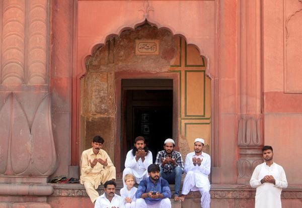 Men say their prayers during Eid al-Fitr to mark the end of the holy fasting mo<em></em>nth of Ramadan at the Badshahi mosque in Lahore.