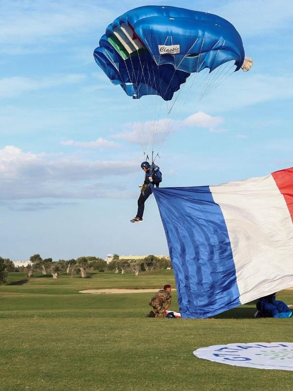 G7 leaders watch as a skydiver drops with his parachute with a flag of France, on the first day of the G7 summit, in Savelletri, Italy.