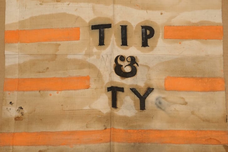 A Whig Party flag from the 1840 presidential campaign with a shortened version of the slogan “Tippecanoe and Tyler Too.”