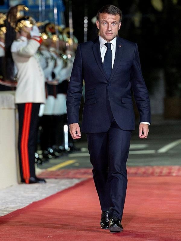 French President Emmanuel Macron arrives to attend a dinner at Swabian Castle in Brindisi, Italy.