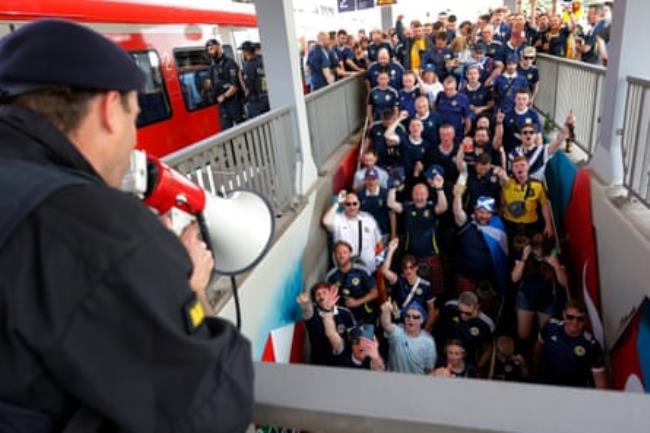 A huge pack of Scottish fans cheer as a delayed train finally tuns up at Cologne main station to take them to a technology park on the outskirts of the city from wher<em></em>e they will walk 25 minutes to the stadium before Scotland’s match against Switzerland.