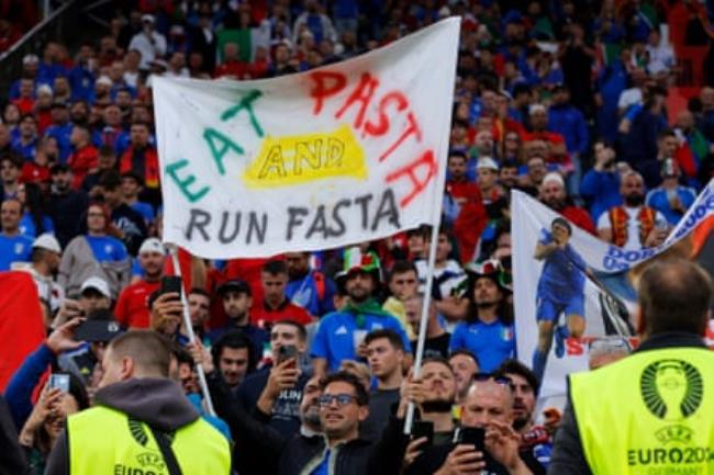 An Albanian fan strikes a pose before Italy v Albania.
