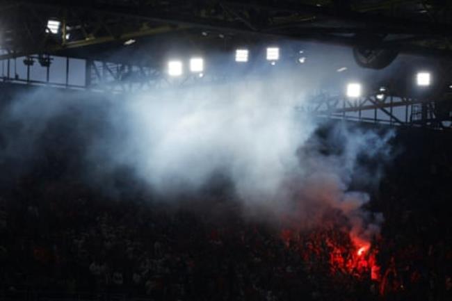 Turkey fans light a flare after their third goal during the 2024 European Champio<em></em>nship group game between Turkey and Georgia.