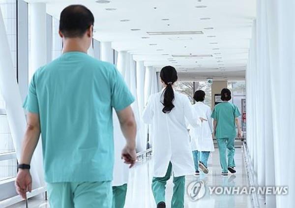 Doctors walk at a general hospital in Seoul in this photo taken June 10, 2024. (Yonhap)