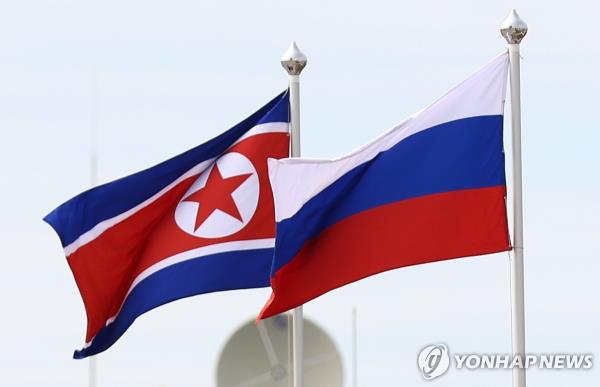 This file photo, released by EPA, shows the flags of North Korea (L) and Russia flying during a visit of Russian President Putin and North Korean leader Kim Jong-un to the Vostochny spaceport in Russia's Far East, on Sept. 13, 2023. (Pool photo) (Yonhap)