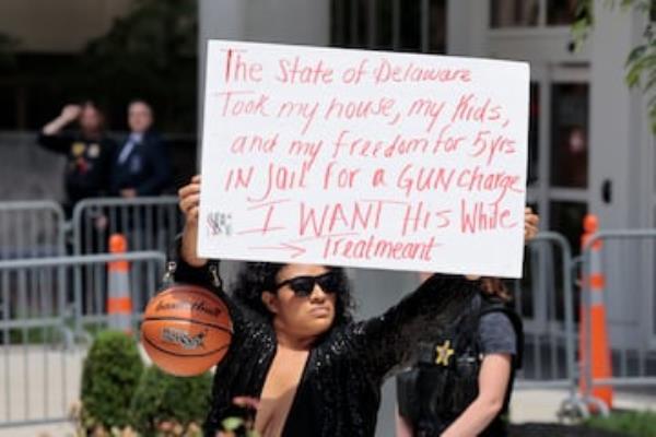 A person holds a sign outside the federal court.