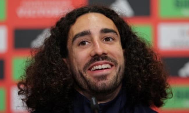 Cucurella smiles during a press conference