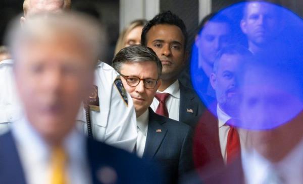 US Speaker of the House Mike Johnson (C) and former presidential candidate Vivek Ramaswamy (C behind Johnson) listen as former President Do<em></em>nald Trump (L) speaks to reporters as he arrives to attend his trial for allegedly covering up hush mo<em></em>ney payments me<em></em>taed to extramarital affairs, at Manhattan Criminal Court in New York City, on May 14, 2024. Trump's former perso<em></em>nal attorney Michael Cohen returns to the witness stand on Tuesday for what is expected to be a tough grilling by the ex-president's lawyers at his historic hush mo<em></em>ney trial. (Photo by JUSTIN LANE / POOL / AFP) (Photo by JUSTIN LANE/POOL/AFP via Getty Images)