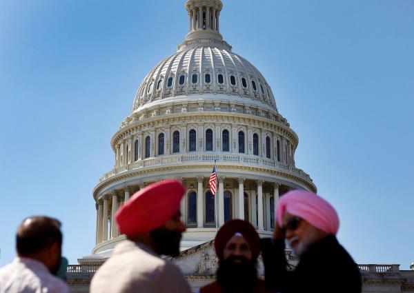 People stand in front of the U.S. Capitol in Washington