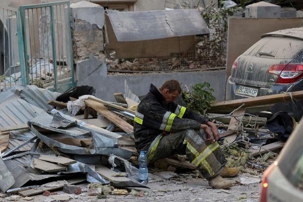 A rescuer rests at the site of a Russian drone and missile strike on residential buildings, amid Russia's attack on Ukraine, in Lviv, Ukraine September 4, 2024