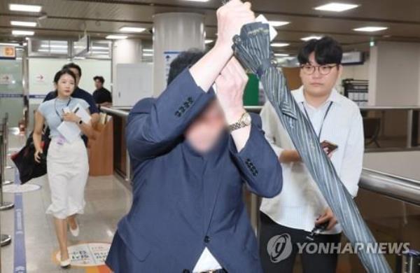 A person, surnamed Sohn, exits the Seoul Central District Court after a ruling on a stock manipulation case involving Deutsch Motors on Sept. 12, 2024. (Yonhap)