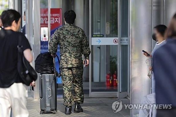 In this file photo, a military doctor enters a building of a major hospital in Seoul on June 16, 2024. (Yonhap)