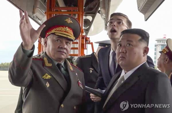 This file photo, provided by Russia's defense ministry and carried by EPA on Sept. 17, 2023, shows North Korean leader Kim Jong-un (R) and Sergei Shoigu, then Russia's defense minister (L), inspecting a military airfield in Russia's Vladivostok the previous day. (PHOTO NOT FOR SALE) (Yonhap)