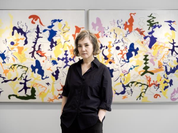 Artist Ham Kyung-ah poses for photos against her artworks on display at Kukje Gallery in Seoul, in this photo provided by the gallery on Aug. 30, 2024. (PHOTO NOT FOR SALE) (Yonhap)