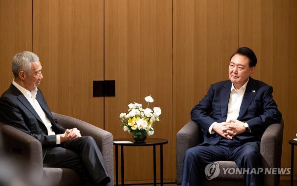 President Yoon Suk Yeol (R) meets former Singaporean Prime Minister Lee Hsien Loong at a hotel in Singapore on Oct. 8, 2024. (Pool photo) (Yonhap)