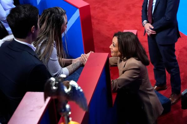 Kamala Harris (right) holds the hand of Ivett Castillo, of Las Vegas, at the co<em></em>nclusion of the Oct. 10 Univision town hall. She emphasized border security in her remarks on immigration.