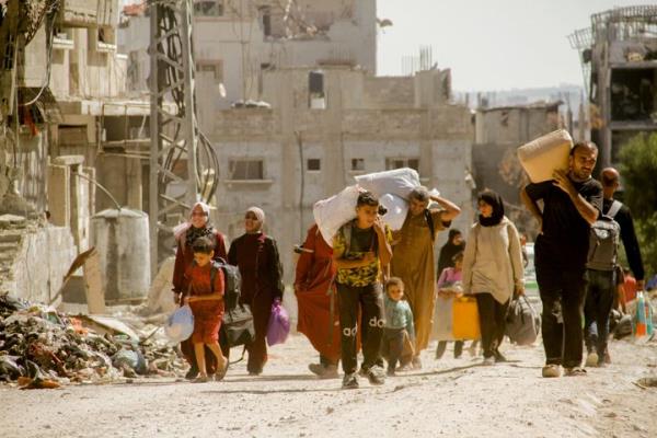 Palestinians carry their belo<em></em>ngings as they flee areas north of Gaza City on October 12, 2024. In recent days, the Israeli military has launched an intense ground and air assault in northern Gaza, particularly in and around the city of Jabalia.