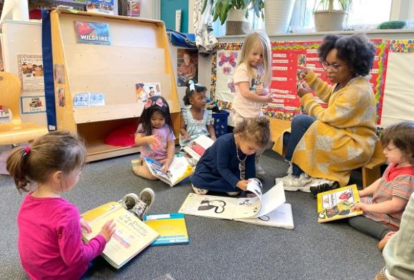 Layla, age 3, turns a page during reading time at Downtown Baltimore Child Care. Her seat at DBCC is funded by Maryland's pre-K expansion grant. (Brooke Conrad/Staff)