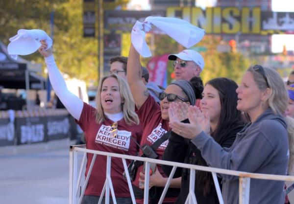 Spectators cheer as runners pass toward the finish line during the 24th Annual Running Festival at the inner harbor. (Karl Merton Ferron/Staff)