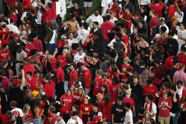 Maryland football fans celebrate their come from behind 29-28 victory over USC on the field at SECU Stadium. (Kim Hairston/Staff)