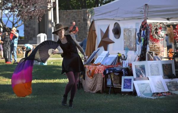 Victoria Lawrence, of Reading, Pa., dances to live music next to her booth which won the best of show in the 61st Havre de Grace Art Show on the waterfront at Tydings Memorial Parks. (Kenneth K. Lam/Staff)