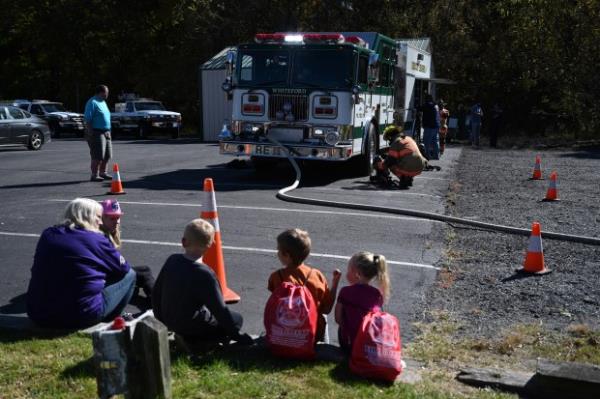 Spectators watch as firefighters prepare for a demo<em></em>nstation during an open house at Whiteford Volunteer Fire Company on Saturday. (Brian Krista/staff photo)