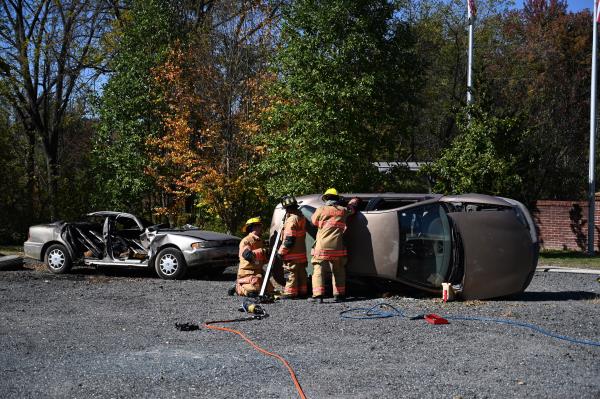 Firefighters work on removing the roof of a car during a vehicle extrication demo<em></em>nstration during an open house at Whiteford Volunteer Fire Company on Saturday. (Brian Krista/staff photo)