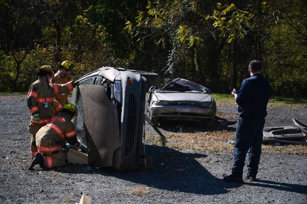 Firefighters work on removing the roof of a car during a vehicle extrication demo<em></em>nstration during an open house at Whiteford Volunteer Fire Company on Saturday. (Brian Krista/staff photo)