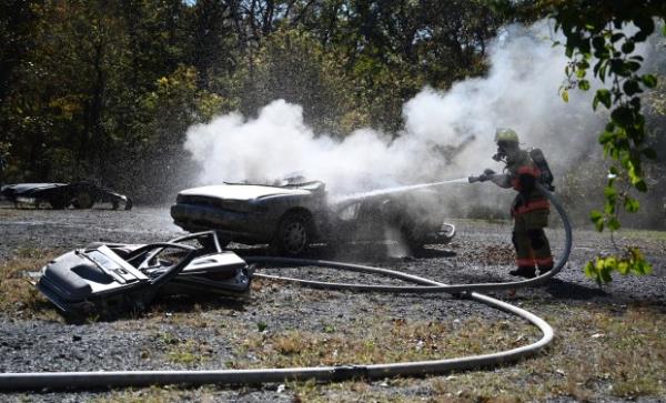 Firefighter Amos Stoltzfus works to put out a fire in a demo<em></em>nstration vehicle during an open house at Whiteford Volunteer Fire Company on Saturday. (Brian Krista/staff photo)