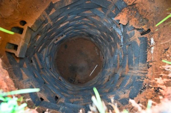 The 30-foot deep well that caved in as homeowner Steve Johnson walked over it Tuesday afternoon. (Jeffrey F. Bill/Staff photo)