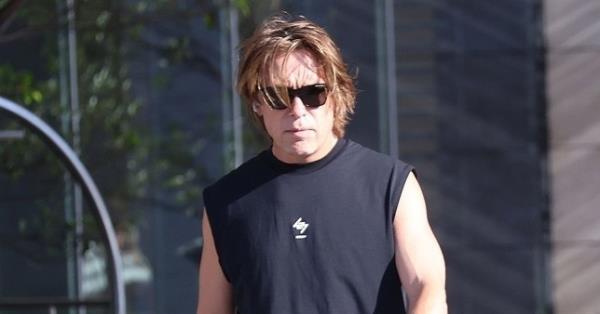 Mark Owen wearing a black t-shirt and black sunglasses during a walk in Australia