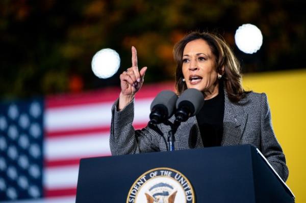 Kamala Harris speaking into a microphone at a lectern during a presidential campaign