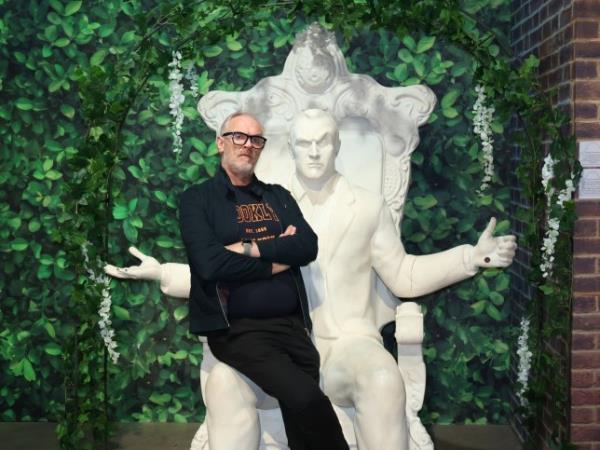 Greg Davies sitting on a clay throne of himself at the Taskmaster Live Experience venue