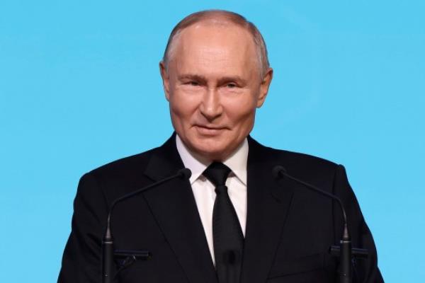 Russian President Vladimir Putin against a blue background. 