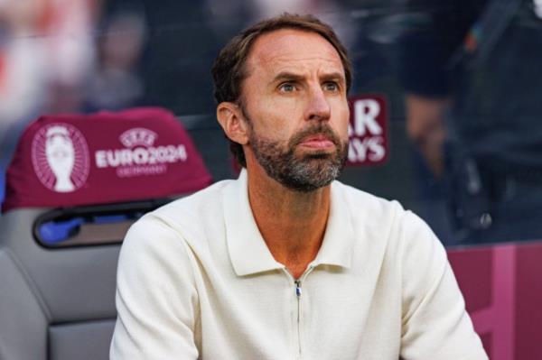 Gareth Southgate in a cream long-sleeved top, sat in a chair at Euro 2024, looking serious