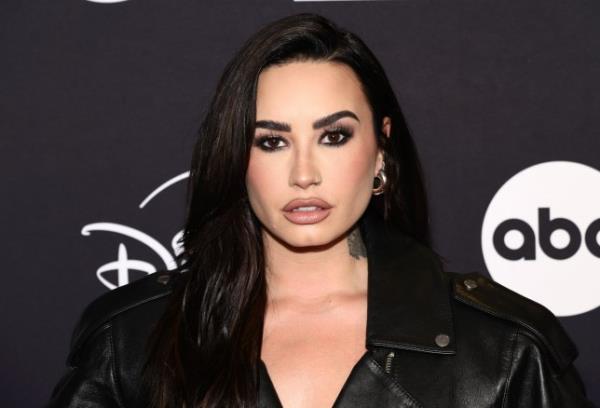 Demi Lovato looking serious in a black leather jacket