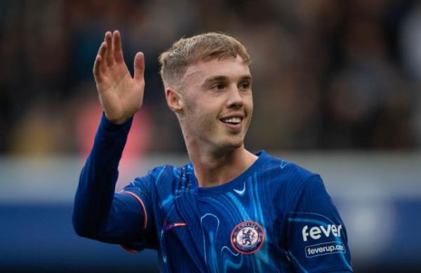 Cole Palmer of Chelsea pictured waving and smiling during a match