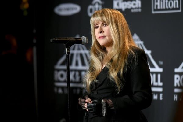 Stevie Nicks, wearing all black, speaks in the press room during the 2019 Rock & Roll Hall Of Fame Induction Ceremony